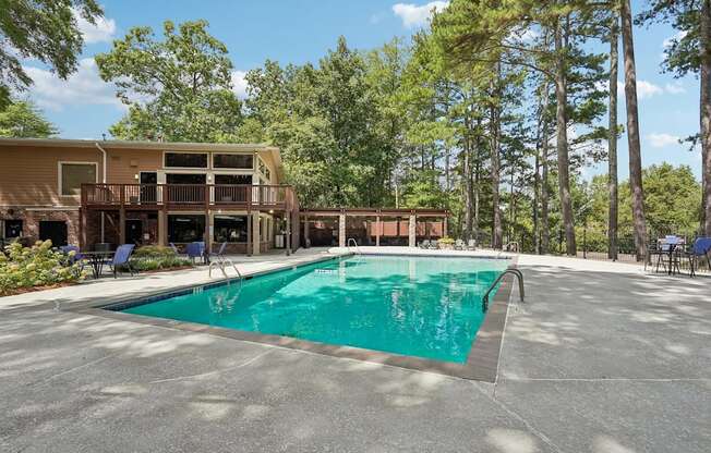 A large swimming pool in front of a resort.