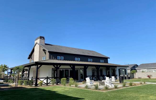 a large house with a lawn and a blue sky