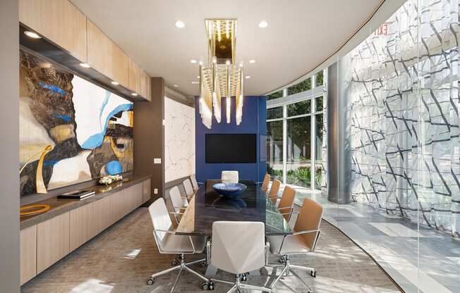 A conference room with a long table and chairs.