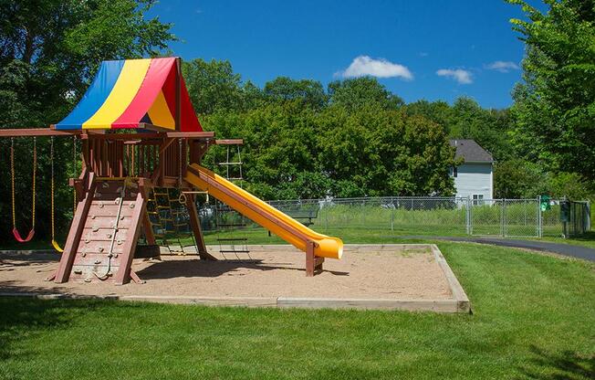 Jungle gym / rainbow playset in an enclosure of sand outdoors