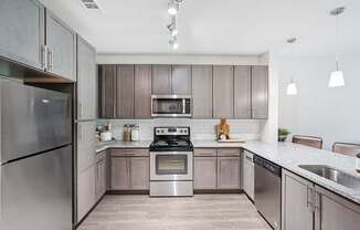 A modern kitchen with stainless steel appliances.