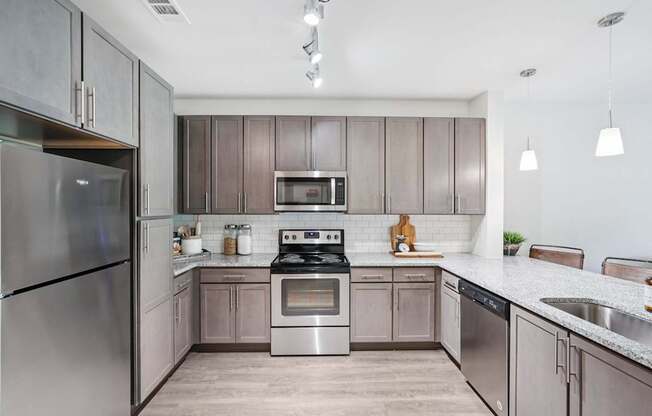 A modern kitchen with stainless steel appliances.