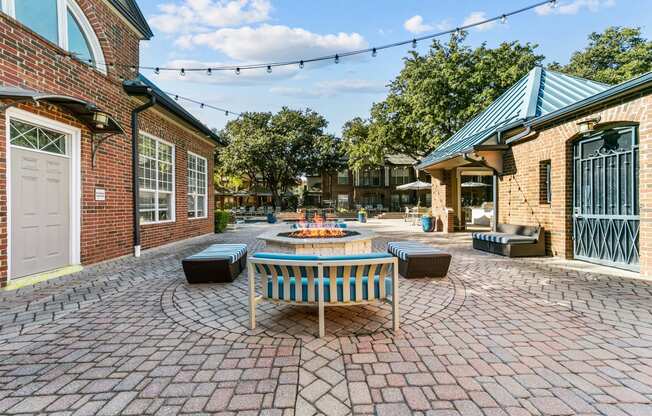 a patio with a table and chairs and a fire pit