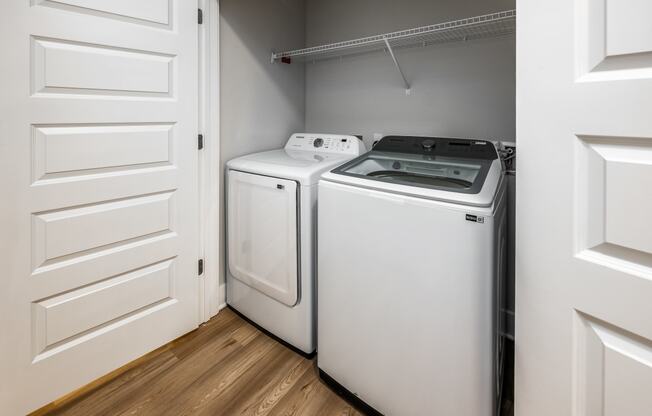 two washers and dryers in a laundry room with white doors at The Alibi at Lake Lilly, Ocoee, FL