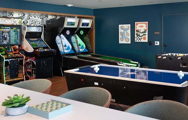 a gaming room with arcade games and tables