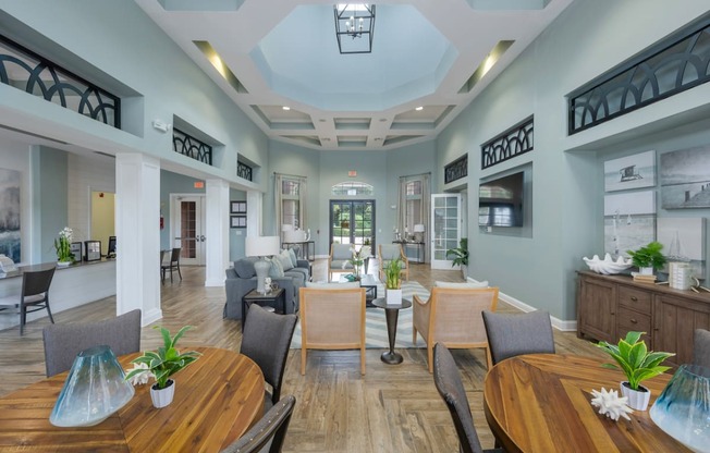 a dining room with tables and chairs and a living room