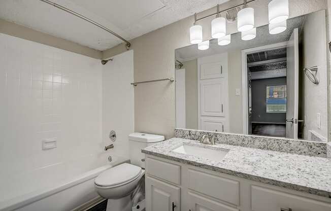 a bathroom with a sink toilet and bathtub