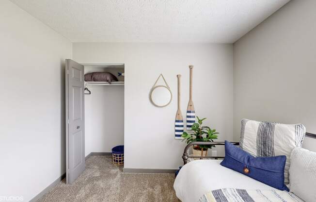 a bedroom with a bed and a closet with a white door