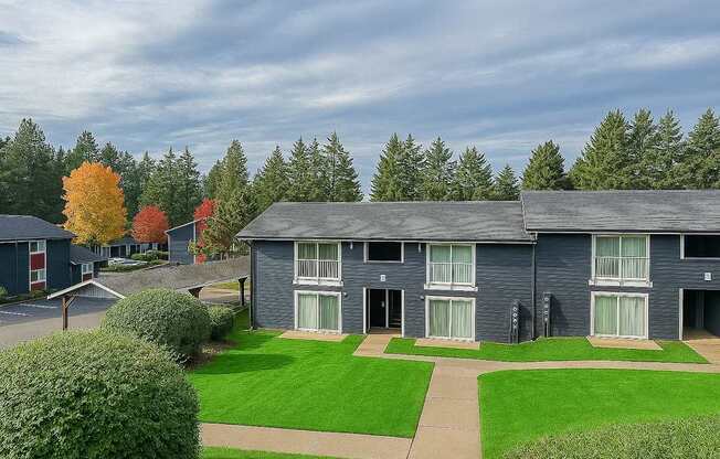 A row of houses with green lawns in front.