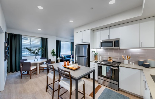 a kitchen and dining room with a table and chairs