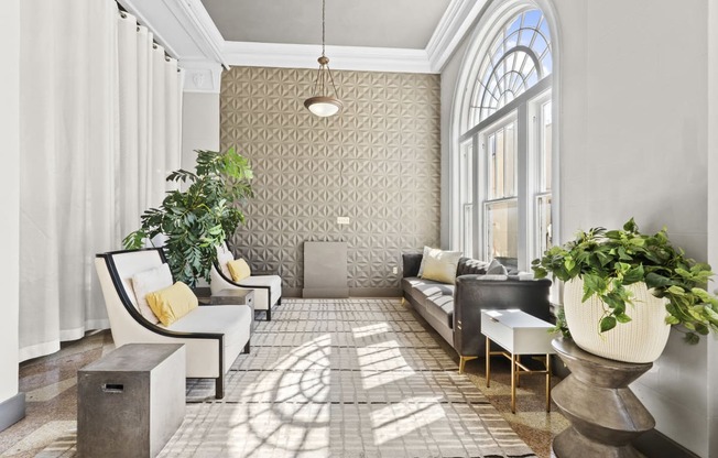 a living room filled with furniture and a large window