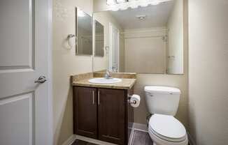 A bathroom with a sink toilet and mirror at Arcadia Townhomes, Federal Way, WA