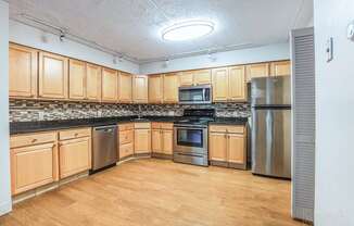 A kitchen with wooden cabinets and stainless steel appliances.