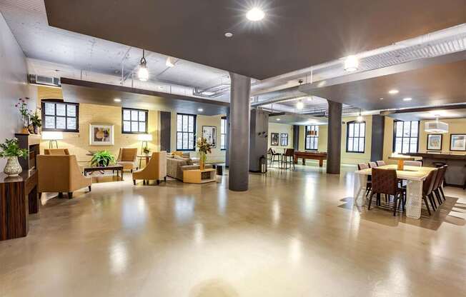 A spacious room with a high ceiling and a mix of modern and vintage furniture.