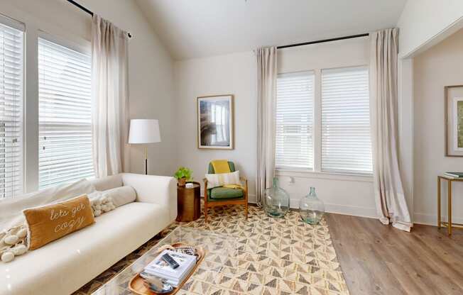 a living room with a white couch and a rug