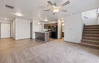 Modern open-concept kitchen and living area with black appliances.