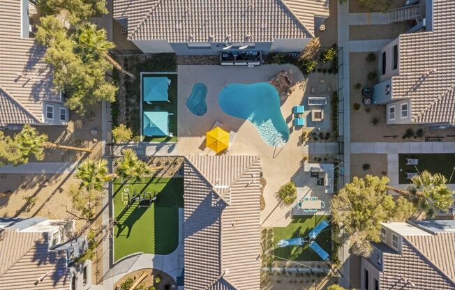 an aerial view of a house with a pool in the backyard