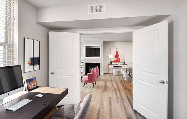 A room with a desk and chairs