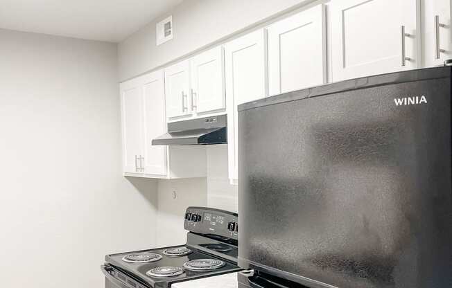 a kitchen with stainless steel appliances and white cabinets