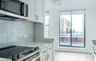a kitchen with a window and a stove and a microwave