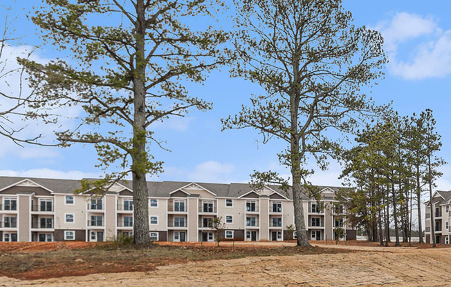 the view of an apartment building with trees in front of it  at Signature Pointe Apartment Homes, Athens