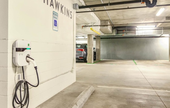 a car is parked in a parking garage next to a white wall