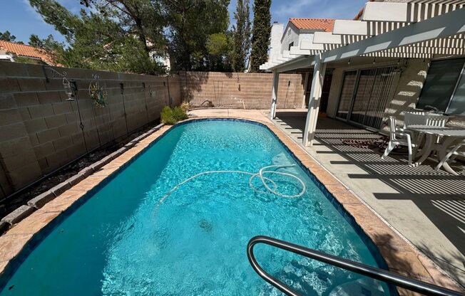 Two story home with sparkling private pool.