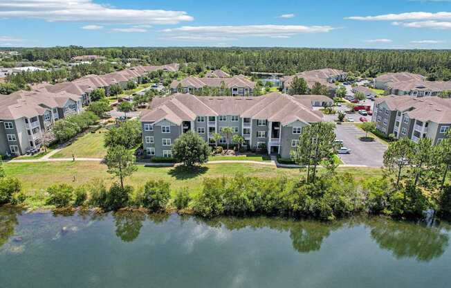 A large body of water is in front of a cluster of houses.