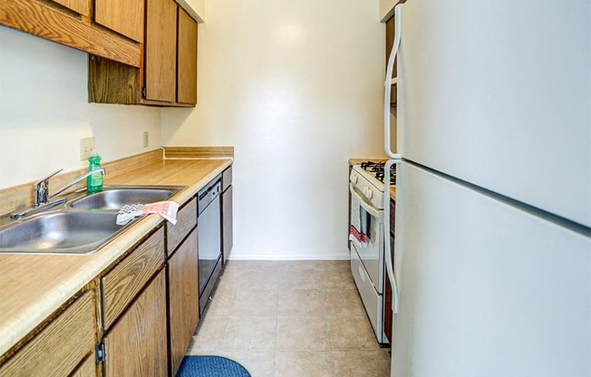 Williamsburg on the Lake Valparaiso's fully equipped kitchen features a gas stove, dishwasher, refrigerator, and cabinets