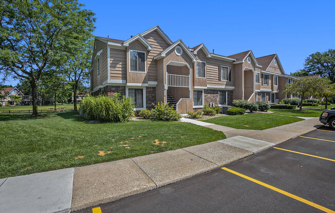 Landscaped grounds with walkways at Hampton Lakes Apartments, Walker, MI, 49534