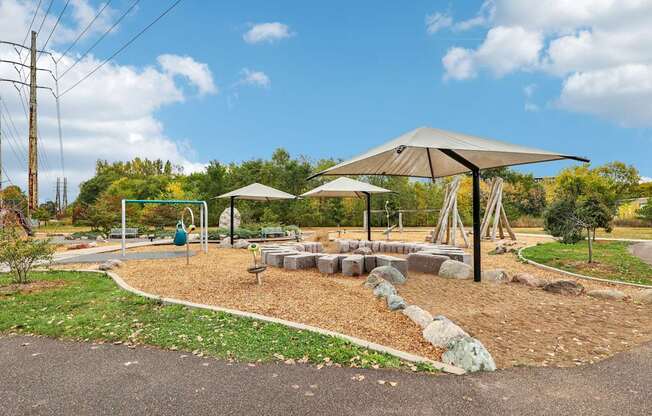 A playground with a swing set and a slide.