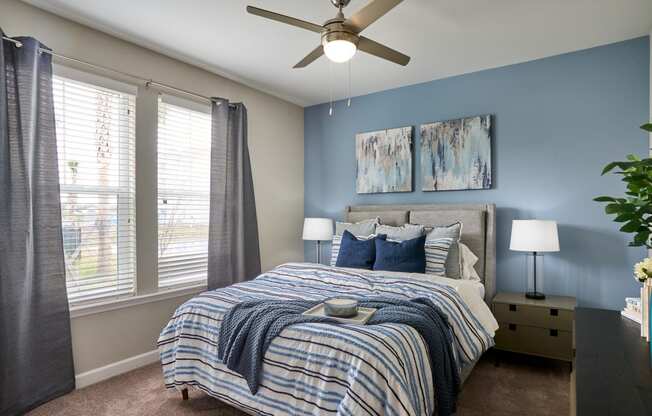 a bedroom with a large bed and a ceiling fan