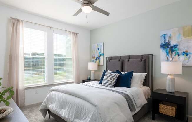 a bedroom with a bed and a ceiling fan