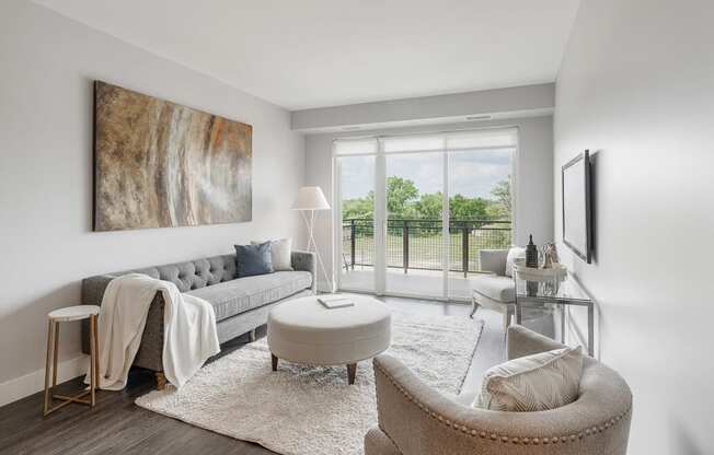a living room with a couch and a chair and a balcony at Barrington 101, Barrington, IL 60010
