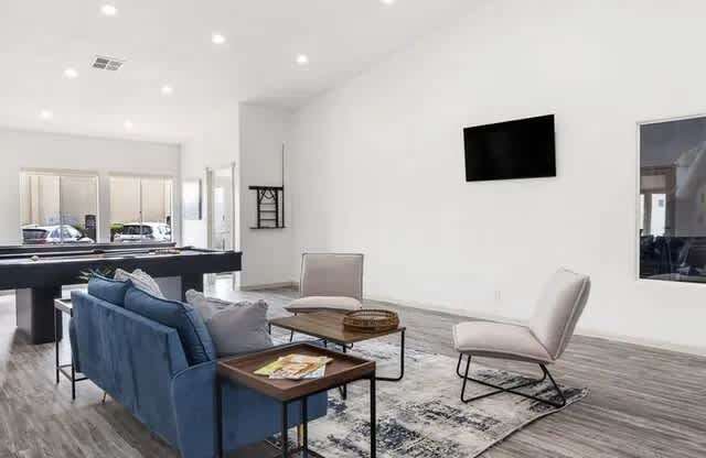 A modern living room with a blue sofa and a wooden coffee table.