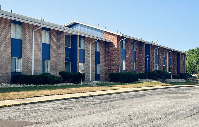 an empty street in front of a brick building