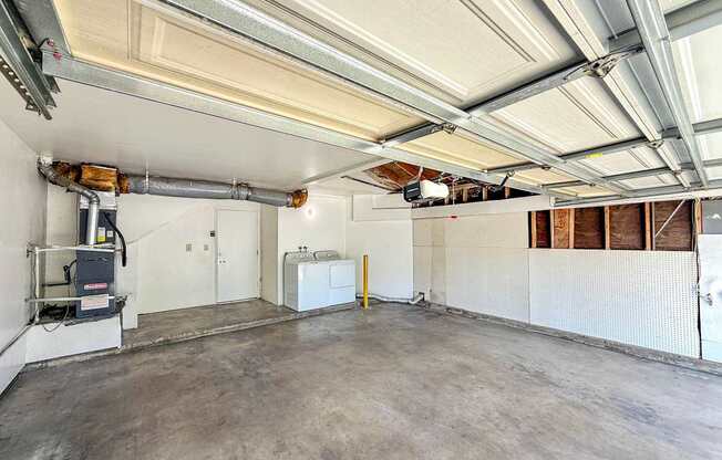 An attached two car garage with a full size washer and dryer.