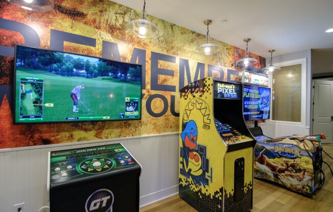 A room with a wall mural that says "Golf" and a row of arcade games.