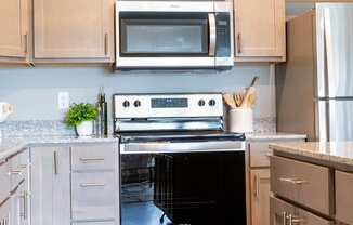 a modern kitchen with stainless steel appliances and white cabinets