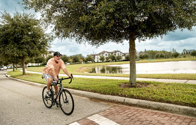 Man riding a bike into the entrance of Lake Nona Water Mark in Orlando, FL