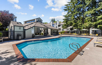 a swimming pool with a house in the background