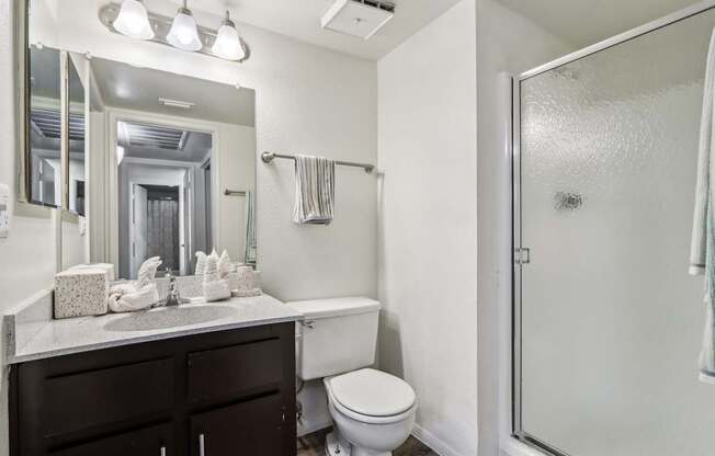 A white toilet sits next to a sink in a bathroom.
