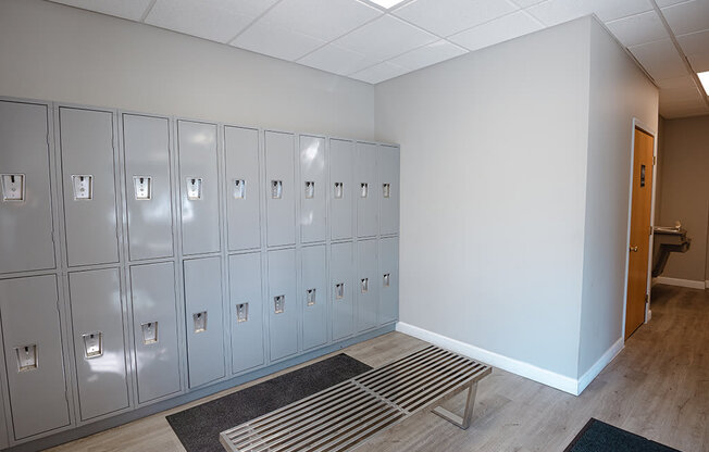 a row of lockers in a room with a bench