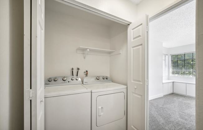 a washer and dryer in a laundry room with a window