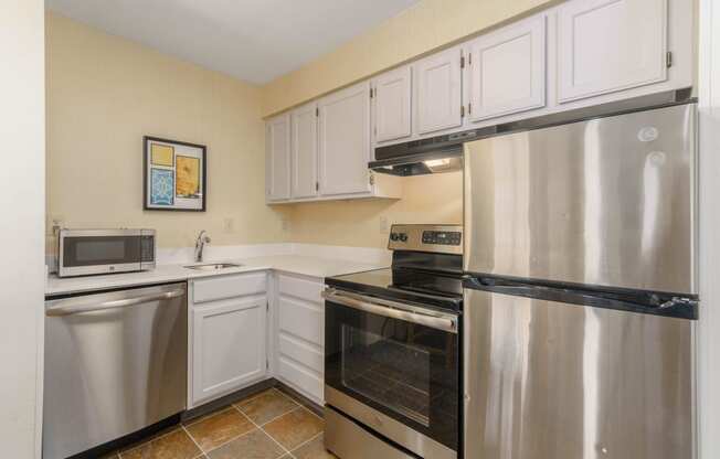 a kitchen with stainless steel appliances and white cabinets