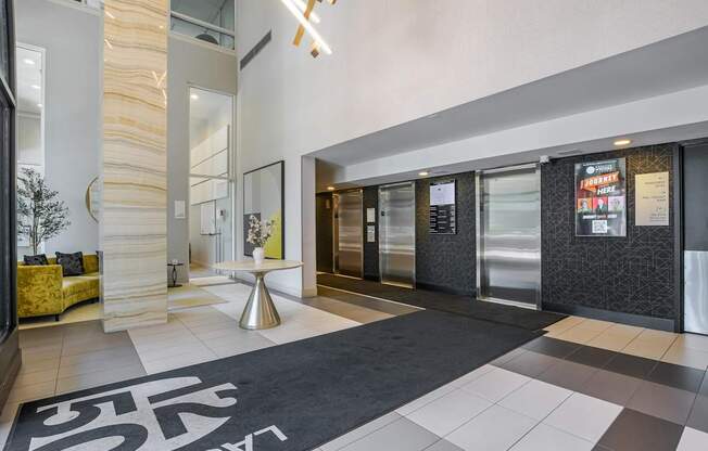 A hallway with a black and white rug on the floor.