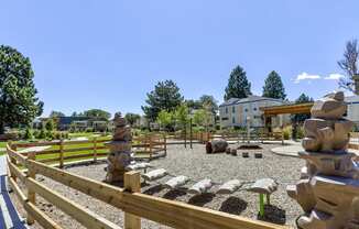 the preserve at ballantyne commons park with statues and a wooden fence