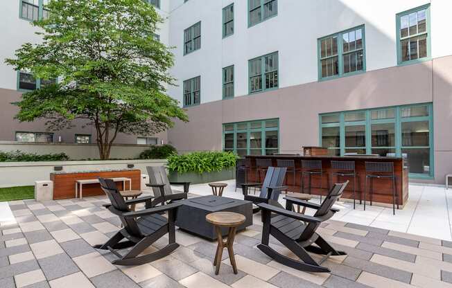 an outdoor patio with tables and chairs and a building in the background at The Cosmopolitan, St Paul