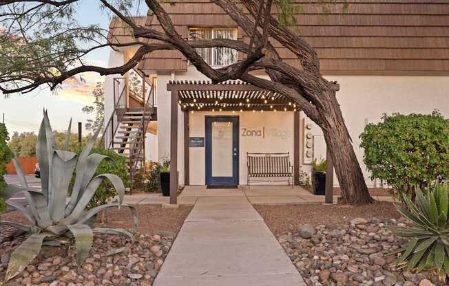 A building with a blue door and a sign that says "Zona Vllage".