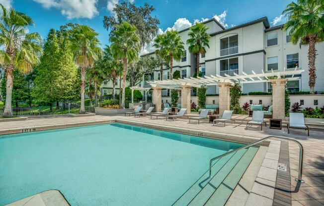 Pool area with lounge seating and umbrellas